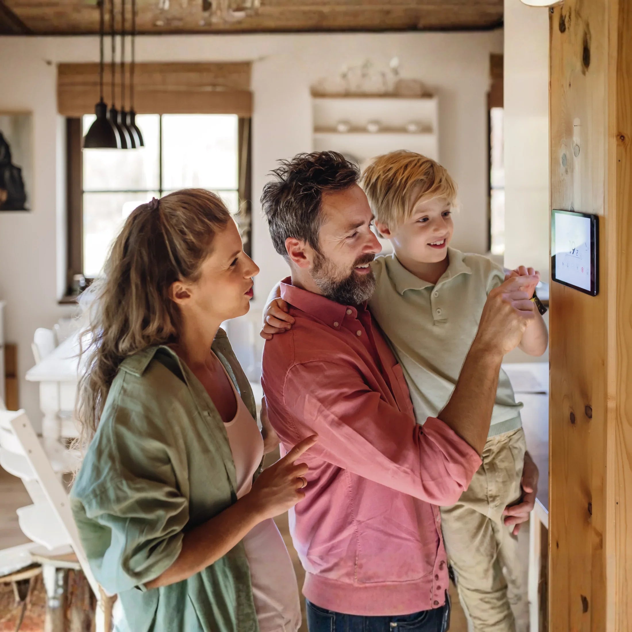Family using smart thermostat in cozy home, adjusting temperature together for comfort and energy savings